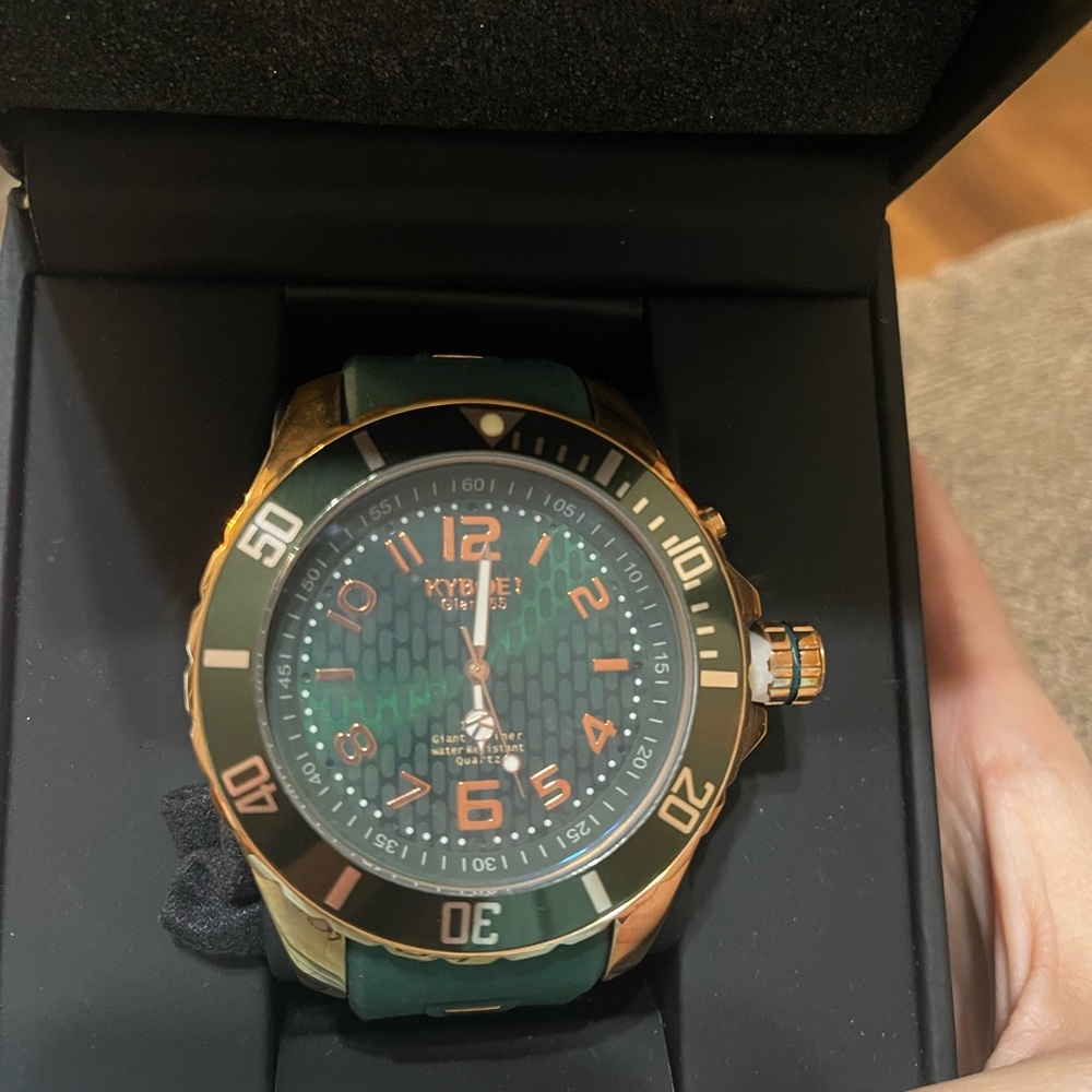 Green and Gold Luxury Watch with Rotating Bezel